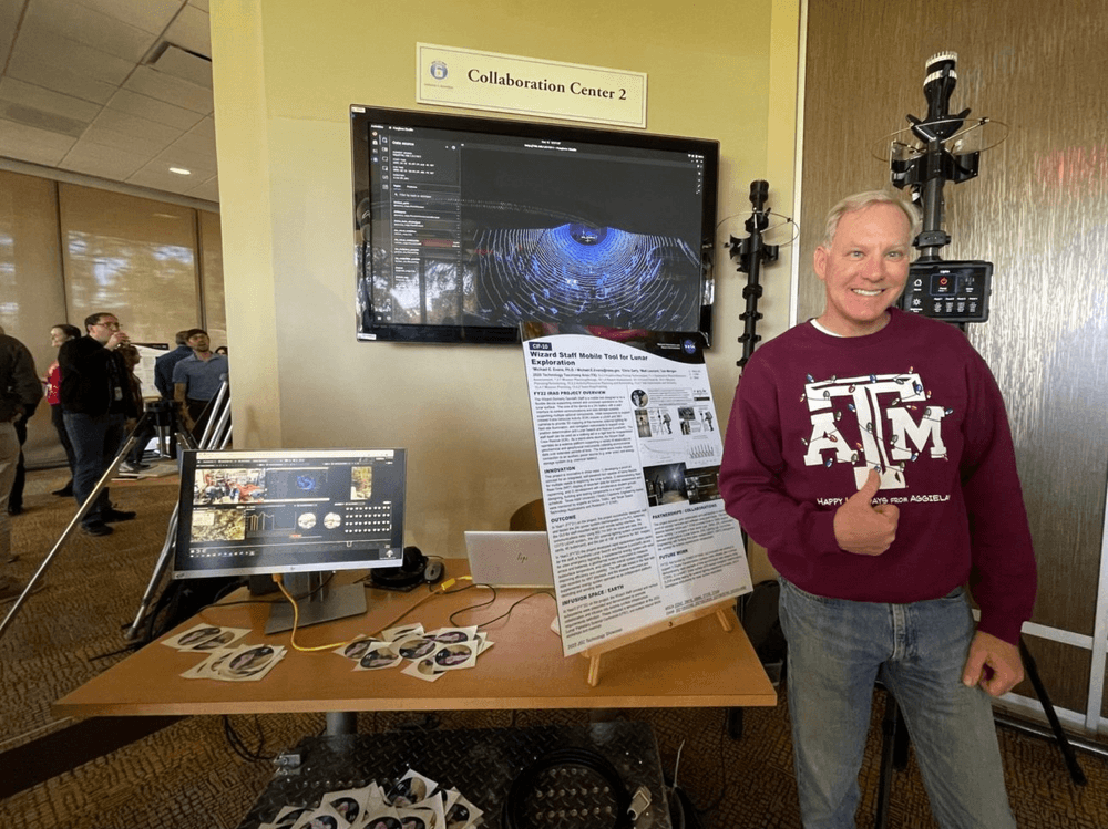 At the annual technology showcase, planetary scientist Dr. Michael Evans from the Astromaterials Research and Exploration Science (ARES) division at NASA’s Johnson Space Center is pictured with the Wizard Staff. Credits: Michael Evans/NASA 